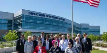 Veterans standing proudly in front of a VA building, symbolizing access to benefits